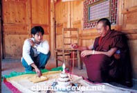 Gendun Khedrup(left), Thangka artist, and his brother, a Lama, pondering a mandala from India, Wutun Villages in Tongren County, Tibet